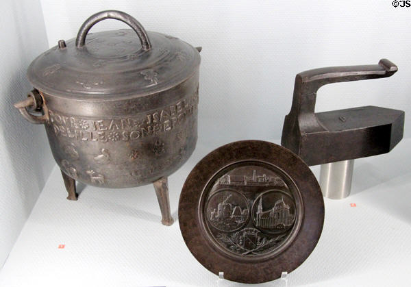 Iron cooking pot (1770), souvenir plate (1888) & iron (early 20thC) at Museum of Normandy. Caen, France.