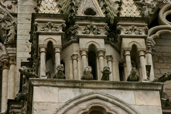 Gargoyles looking out from gallery on Amiens Cathedral. Amiens, France.