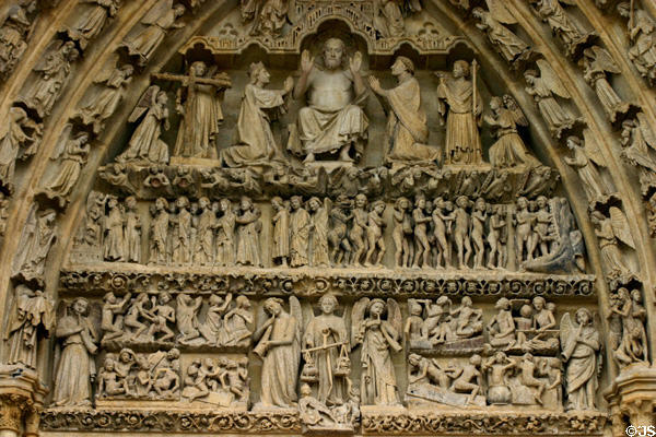 Central portal with angels & Christ over Last Judgment story of Amiens Cathedral. Amiens, France.