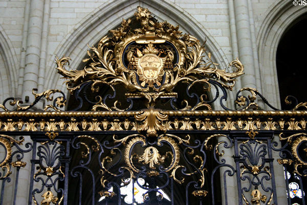 Ornate wrought iron & gilded gate with crest at Amiens Cathedral. Amiens, France.