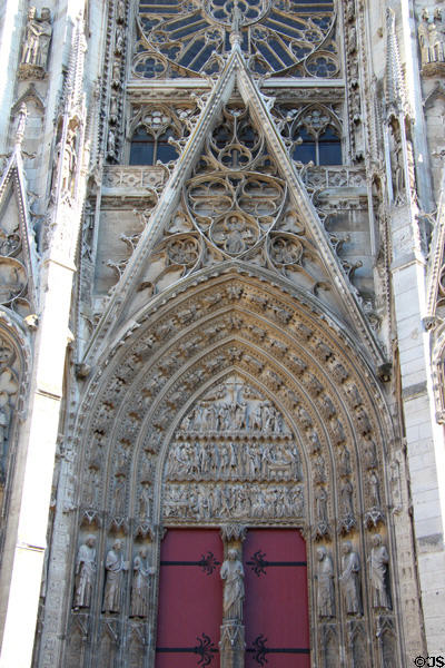 Southern archway entrance with Crucifixion scene at Rouen Cathedral. Rouen, France.