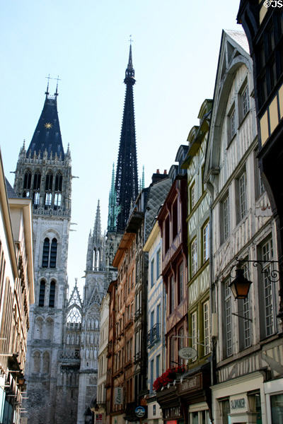 Cathedral spires beyond half-timbered buildings on rue du Gros Horloge. Rouen, France.