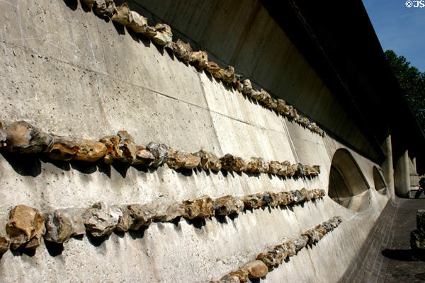 Embedded rocks in cement wall at St Joan of Arc Church. Rouen, France.