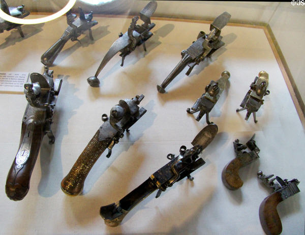 Percussion lighters (briquets-pistolet) (17thC-19thC) from France used same mechanism as flintlocks rifles to ignite fires (before matches) at Wrought Iron Museum. Rouen, France.