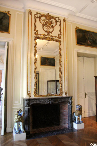 Fireplace with gilded mirror at Rouen Ceramic Museum. Rouen, France.