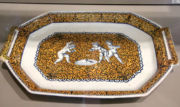 Rouen-made earthenware platter with handles painted with children playing tops (c1725) at Rouen Ceramic Museum. Rouen, France.