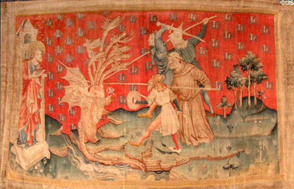Dragon fights servants of God from Apocalypse Tapestry at Angers Chateau. Angers, France.