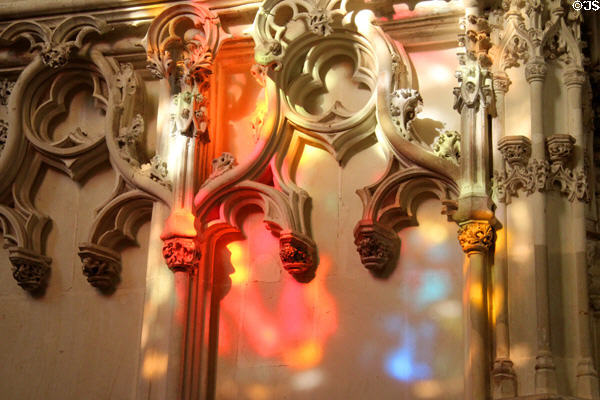 Sunlight through stained glass on ornate carving in St. Hubert's Chapel at Chateau Royal of Amboise. Amboise, France.