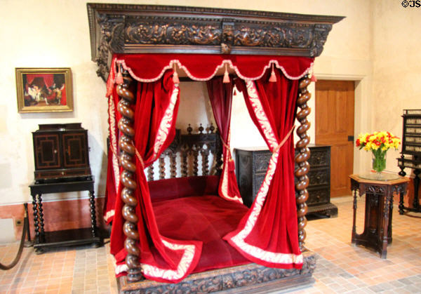Ornately carved Renaissance canopy bed with hangings in bedroom of Leonardo da Vinci at Château de Clos Lucé. Amboise, France.