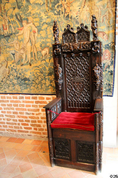 Ornately carved throne chair with crest of France in Great Hall at Château de Clos Lucé. Amboise, France.