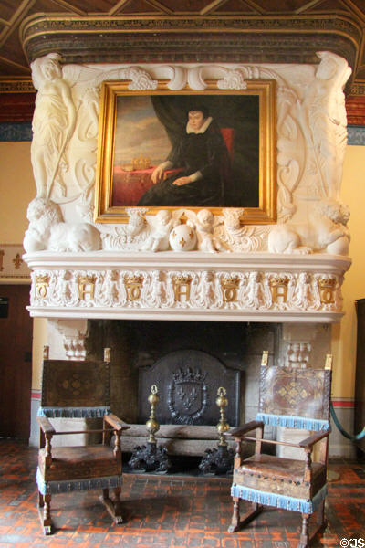 Fireplace carved with initials of Henry II & Catherine de' Medici by Jean Goujon frames a portrait of Catherine by Sauvage in Diane de Poitiers' bedroom at Chenonceau Chateau. Chenonceau, France.