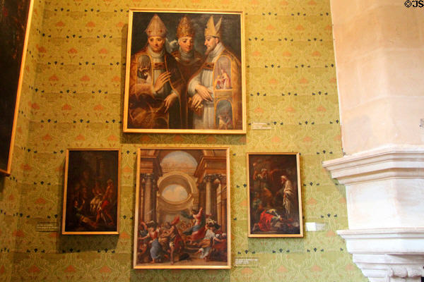 Three Bishops painting by José Ribera over other paintings like Jesus chasing Merchants from Temple by Jouvenet (center) in Green Study at Chenonceau Chateau. Chenonceau, France.