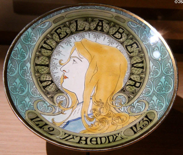 Joan of Arc as shepherdess painted on plate (1899) by Lucien Marchal of Earthenware of Lunéville in Royal Lodgings museum at Château de Chinon. Chinon, France.