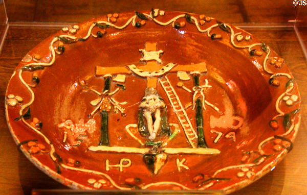 Ceramic votive dish with Crucifixion with instruments of Passion (1574) marked HP K in King's room at Chaumont-Sur-Loire. France.