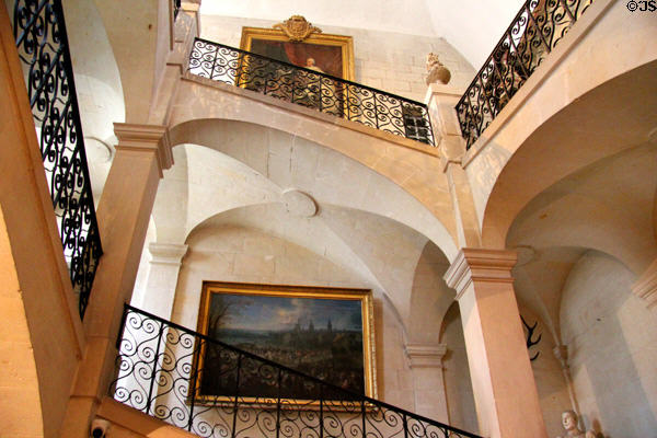 Grand staircase with wrought iron railing plus paintings at Chateau D'Ussé. Ussé, France.