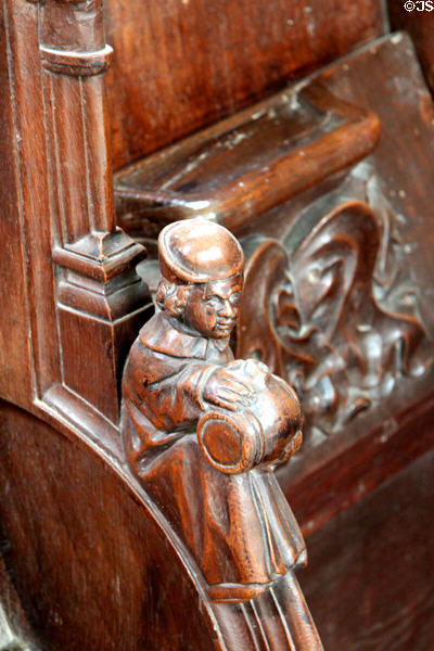 Carved monk with barrel detail on choir stall (1528) in Chapel at Chateau D'Ussé. Ussé, France.