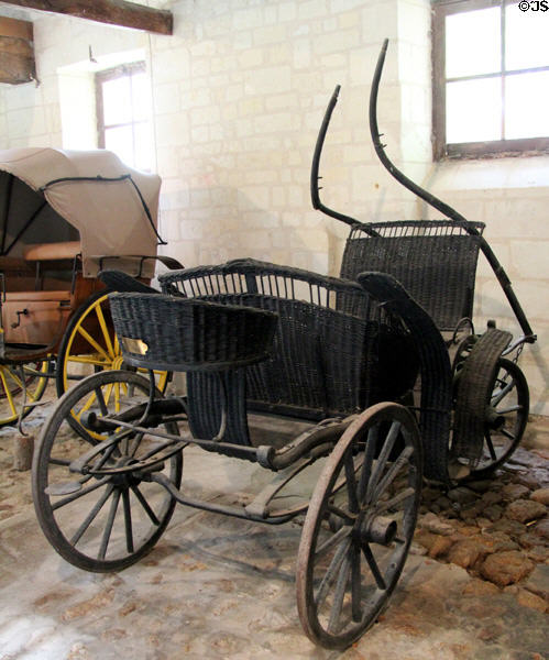 Petit Duc horse carriage made of whicker for drives in the park in stables at Chateau D'Ussé. Ussé, France.