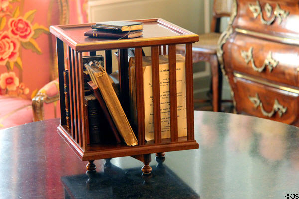 Small tabletop rotary bookshelf in Petit Salon at Cheverny Chateau. Cheverny, France.