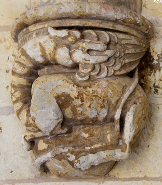 Fire breathing dragon carved on column base around cloister at Fontevraud Abbey. Fontevraud, France.