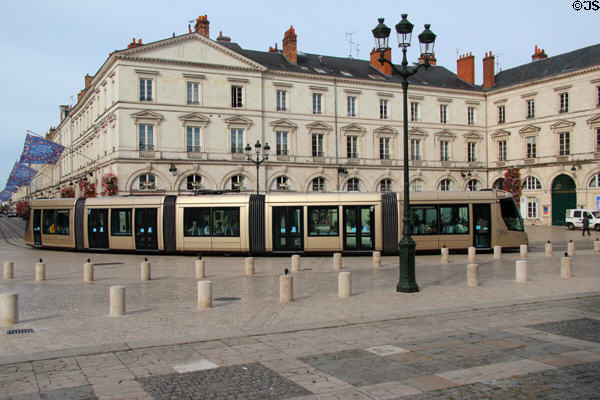 Tram rounds corner at Place Ste. Croix. France.