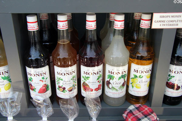Fruit syrups in shop window on Place Ste. Croix. France.