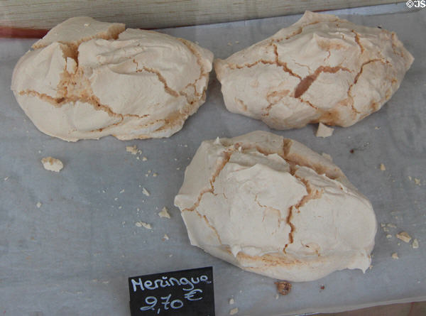 Meringues in shop window on Place St Croix. France.