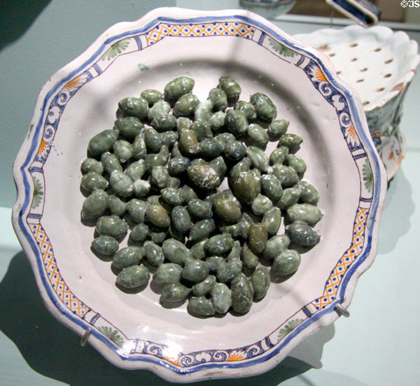 Trompe l'oeil faience plate with fake olives (18thC) from France at Orleans Beaux Arts Museum. Orleans, France.