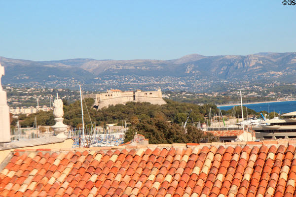View of rooftops, fort & mountains of Côte d'Azur. Antibes, France.