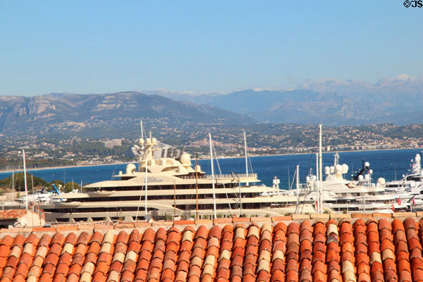 Luxury yacht with mountain Côte d'Azur backdrop. Antibes, France.