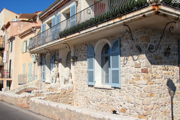 Rough-hewn stone house with iron balcony in Old Antibes. Antibes, France.