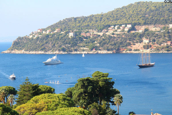 View of yacht & sailing ship from garden at Villa Ephrussi de Rothschild. Saint Jean Cap Ferrat, France.