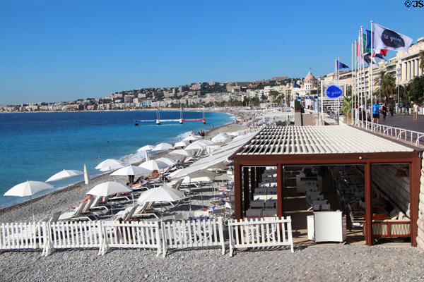 Beach chairs & umbrellas along Promenade des Anglais. Nice, France.