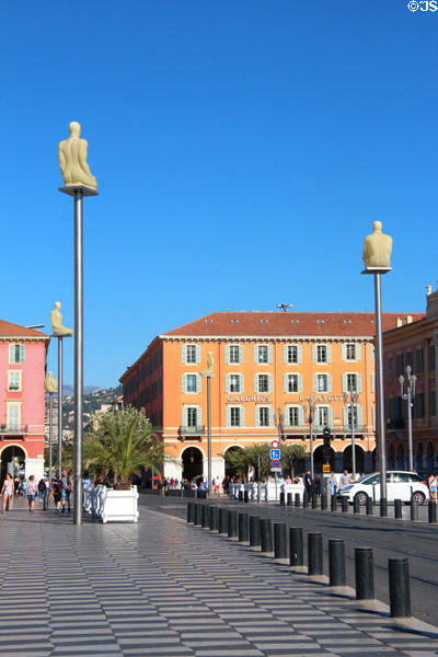 Set of statues on platforms, geometric pavement & arcaded building along Promenade du Paillon. Nice, France.