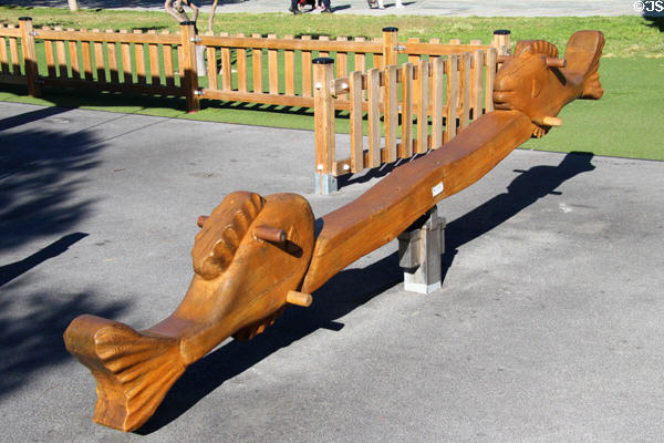 Wooden seesaw with fish seats in children's play area at Promenade du Paillon. Nice, France.
