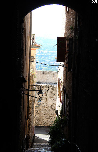 View through narrow passage of valley below town. St Paul de Vence, France.
