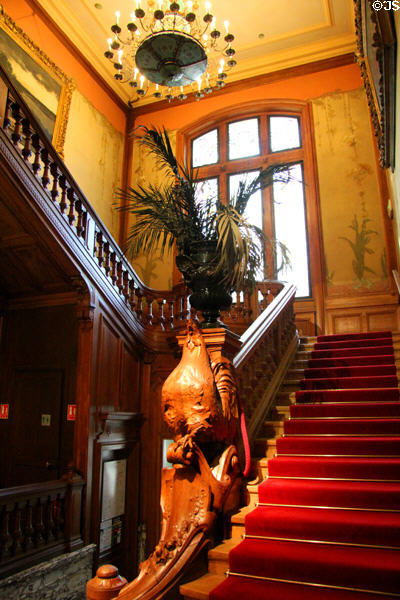 Entrance staircase with carved newel post at Lumière Museum. Lyon, France.