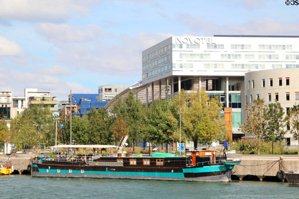 River houseboat with Novotel & modern architecture of Confluence district. Lyon, France.