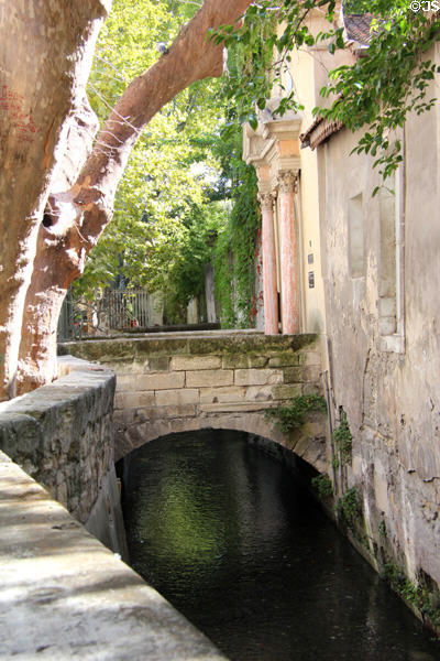 Historic neighborhood of rue des Teinturiers along river which once ran water wheels used by fabric workers. Avignon, France.