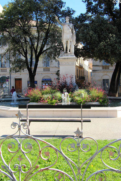 Iron fence of Antonin Square surrounds fountain & Antonius Pius sculpture. Nimes, France.