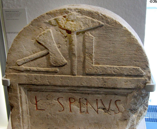 Roman marble epitaph of Lucius Spinus with carved reliefs of stonecutters tools (1stC) from Nimes site on rue Jean Reboul at Musée de la Romanité. Nimes, France.