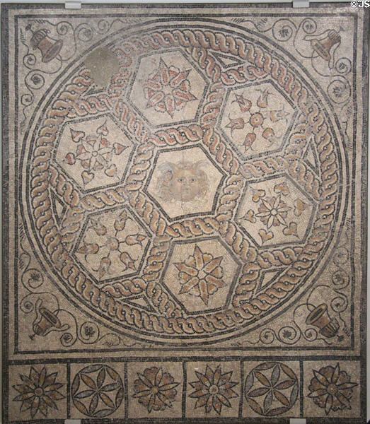 Roman mosaic floor with face in center of hexagonal patterns (c1st-2ndC) from Nimes at Musée de la Romanité. Nimes, France.