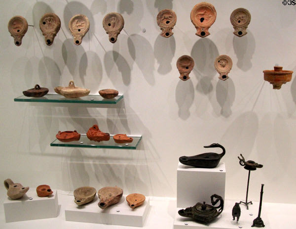 Collection of Roman ceramic & bronze oil lamps (2ndC BCE - 3rdC CE) at Musée de la Romanité. Nimes, France.