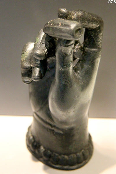 Roman-era bronze votive offering statue (end 3rdC) of hand holding oval sick organ in need of cure at Arles Antiquities Museum. Arles, France.