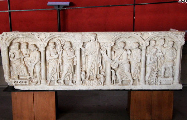 Carved Christ giving scroll of laws to St Peter surrounded by other Apostles on marble sarcophagus (end 4thC) at Arles Antiquities Museum. Arles, France.