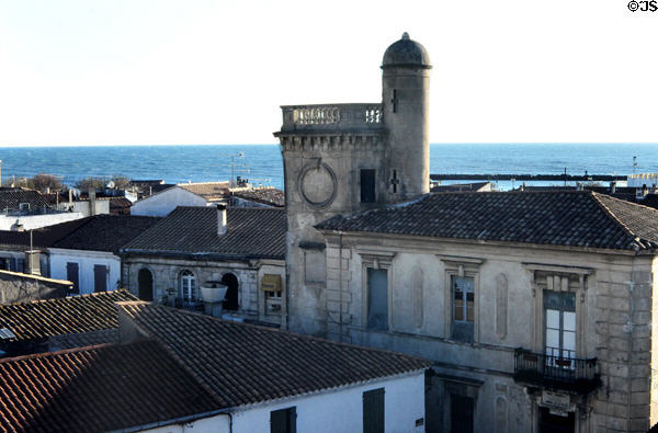 Former Town Hall (19thC) now Baroncelli Museum with Mediterranean beyond seen from Fortified Church. Saintes-Maries-de-la-Mer, France.