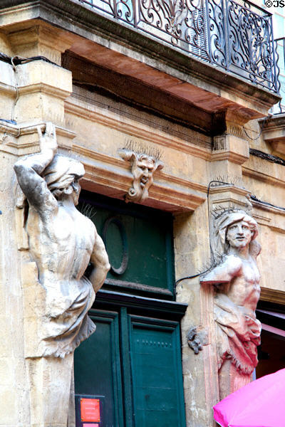 Door surround with sculpted figures near town hall. Aix-en-Provence, France.