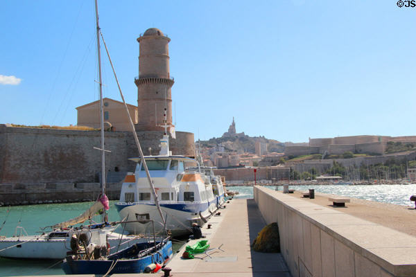Fanal tower (1644) at mouth of Marseille harbor with Basilique Notre-Dame de la Garde beyond. Marseille, France.