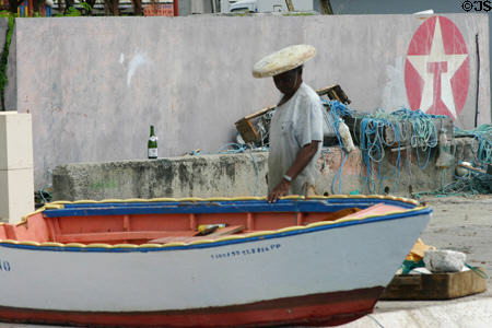 Fisherman tends his boat. St François, Guadeloupe.
