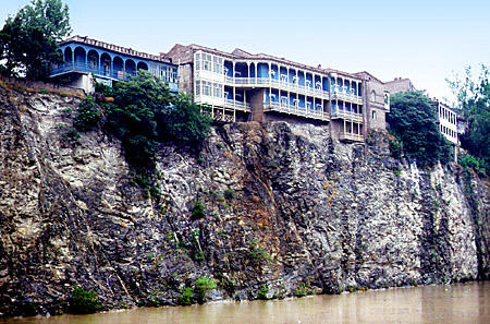 Balconied houses above the Kura River in Tbilisi. Georgia.