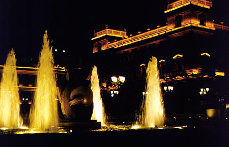 Fountain at night in City Hall square against national bank buildings, Athens. Greece.